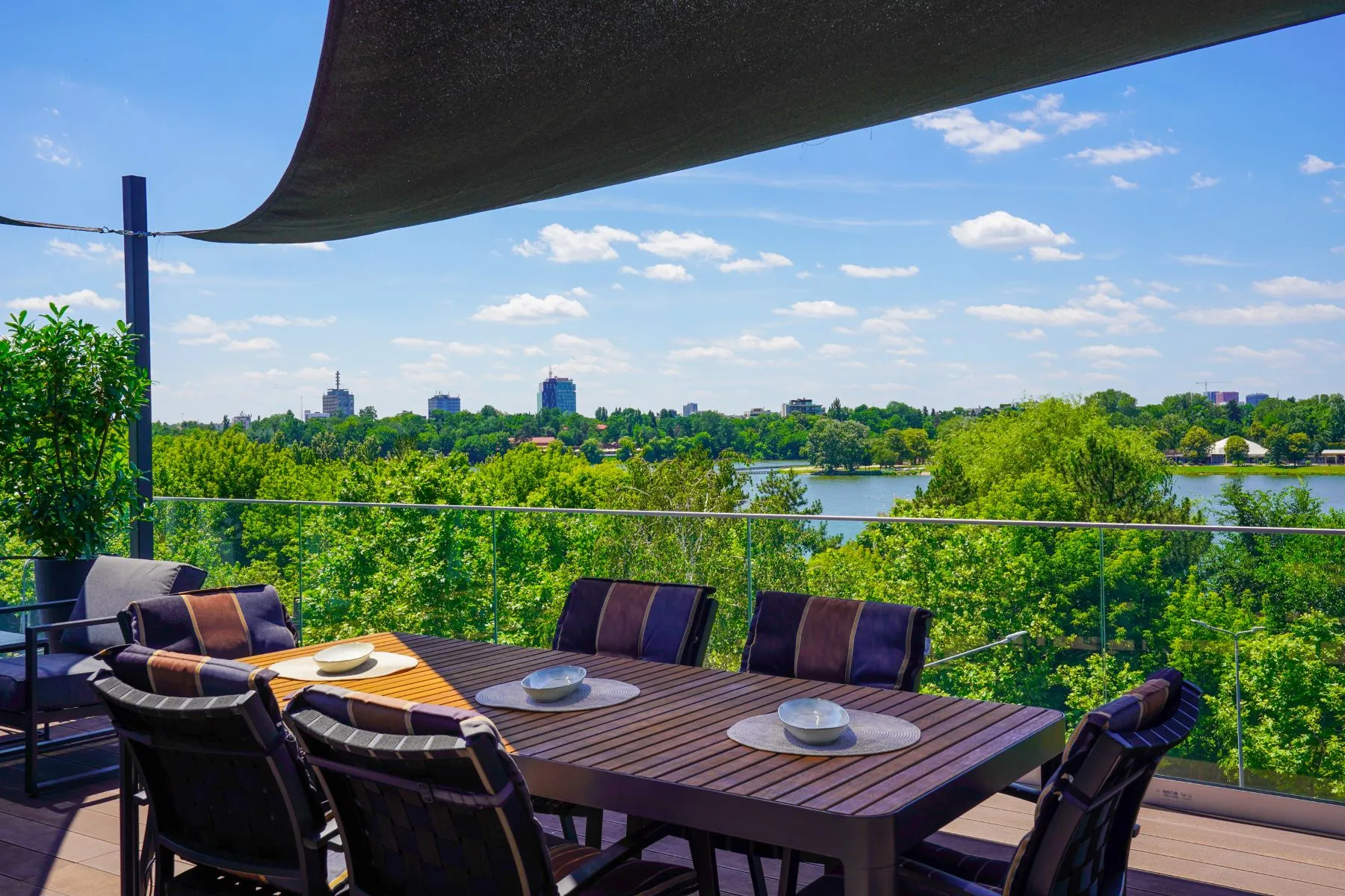 Outdoor dining table on the rooftop terrace overlooking Lake Floreasca