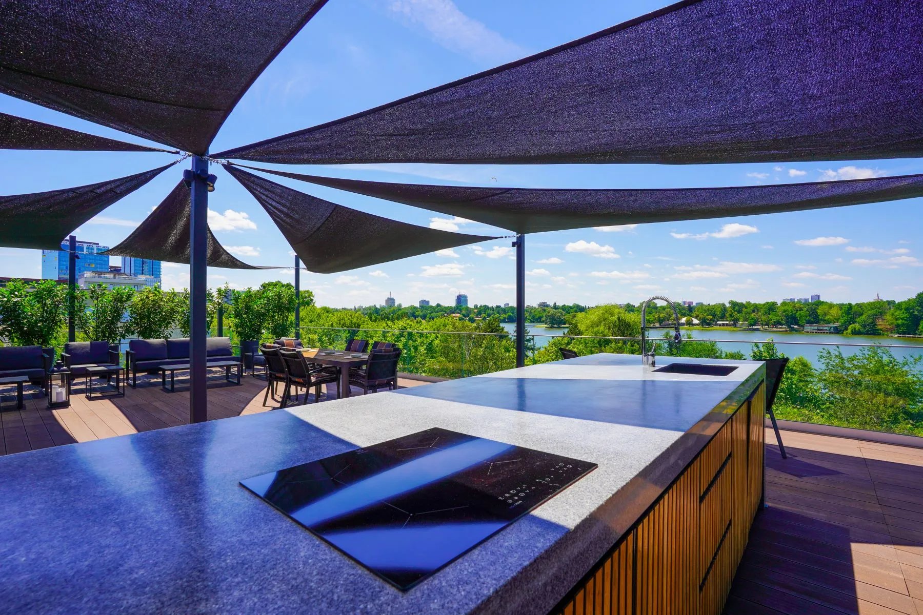 Rooftop cooking island and lounge beneath sculptural sun shades