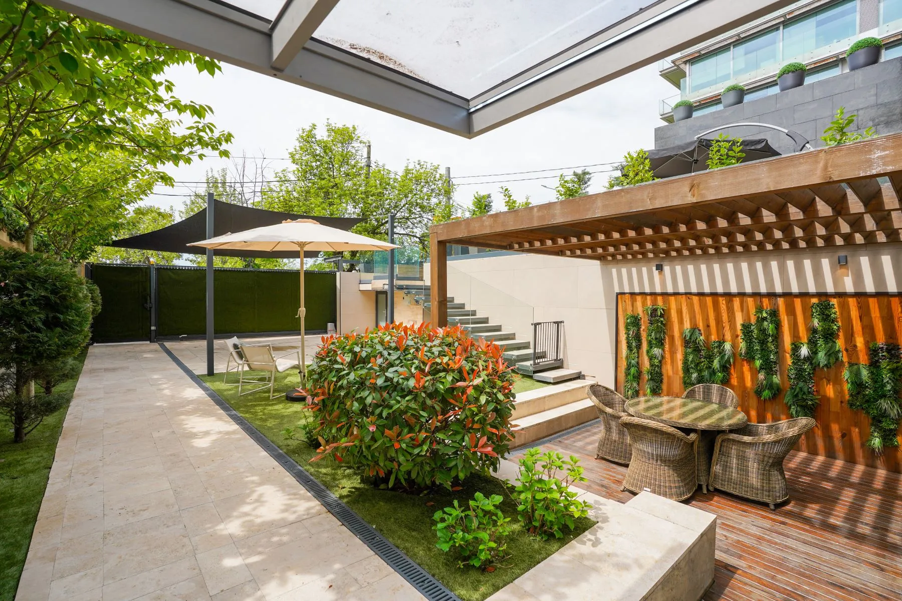 Landscaped private courtyard with pergola, flowers and outdoor seating