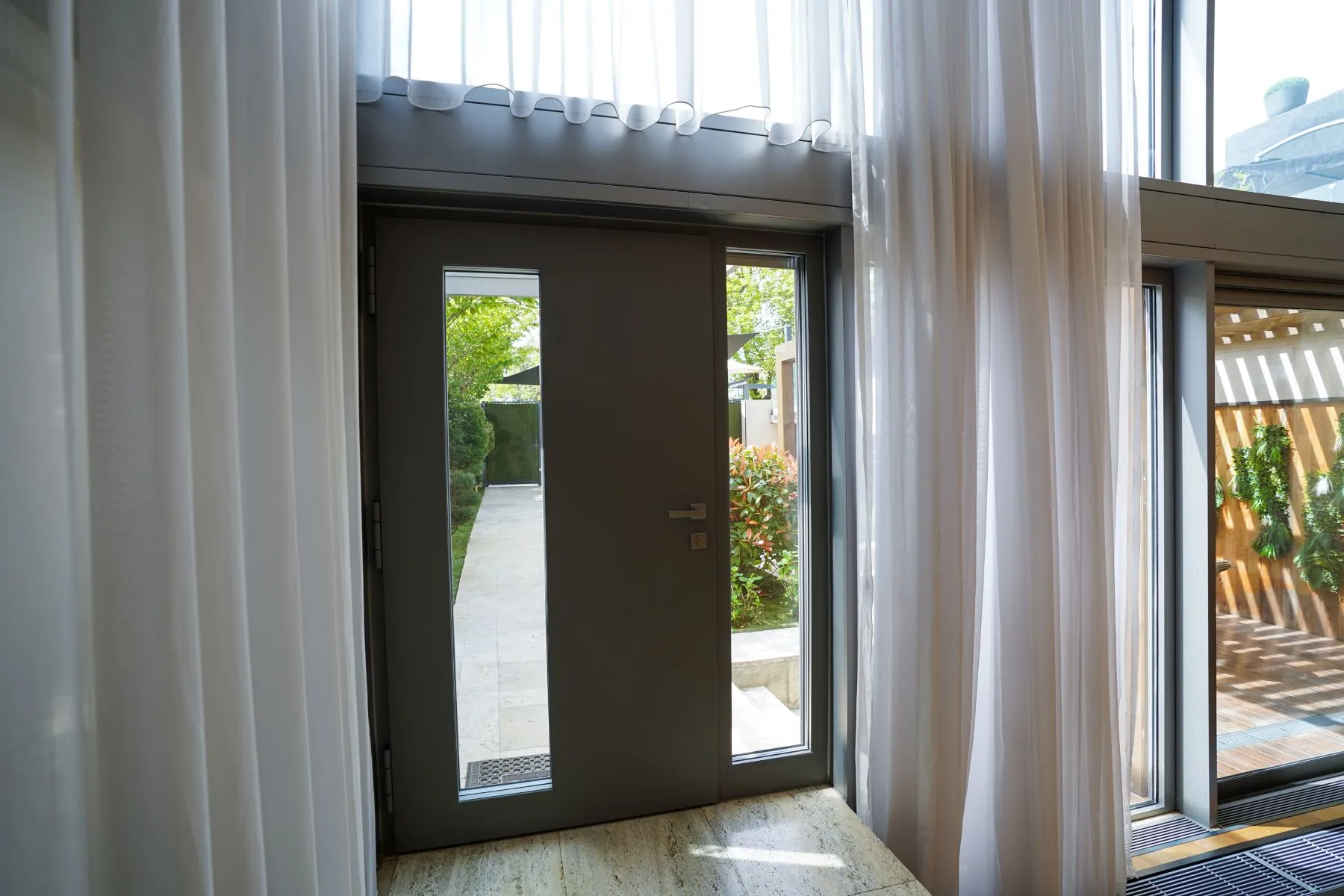 Full-height glazed doors connecting the villa interior with the courtyard