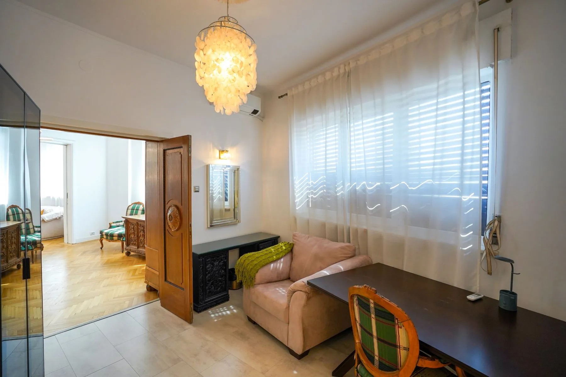 Private sitting room with sofa, writing desk and Calea Victoriei windows