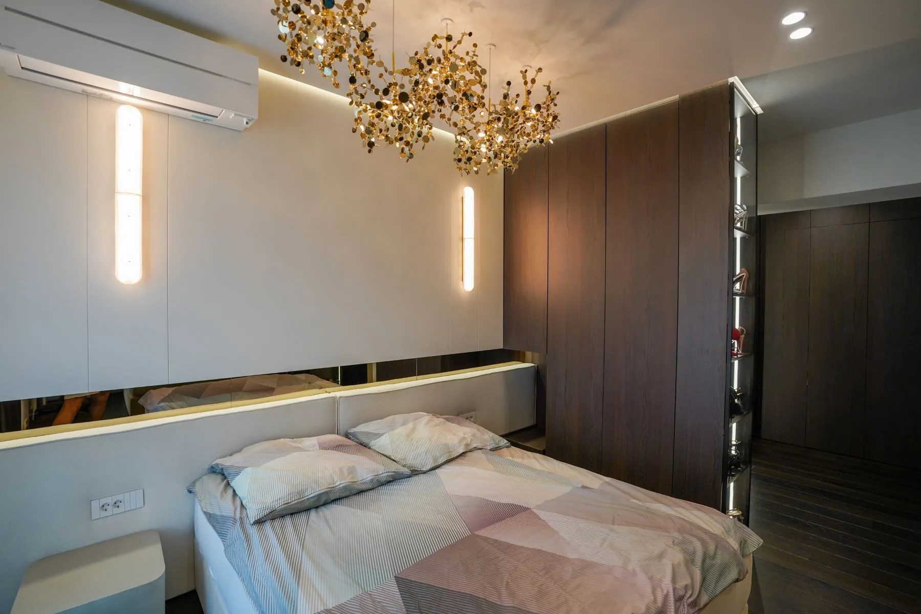 Designer principal bedroom with air conditioning and illuminated timber panelling