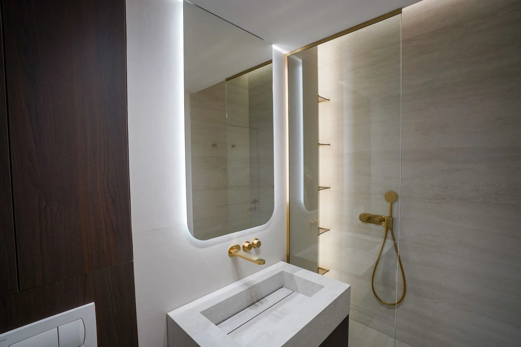 Modern bathroom with glass walk-in shower and illuminated mirror