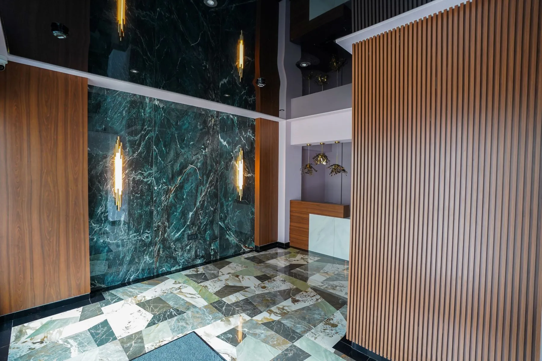 Polished residential entrance with green marble wall and timber screening