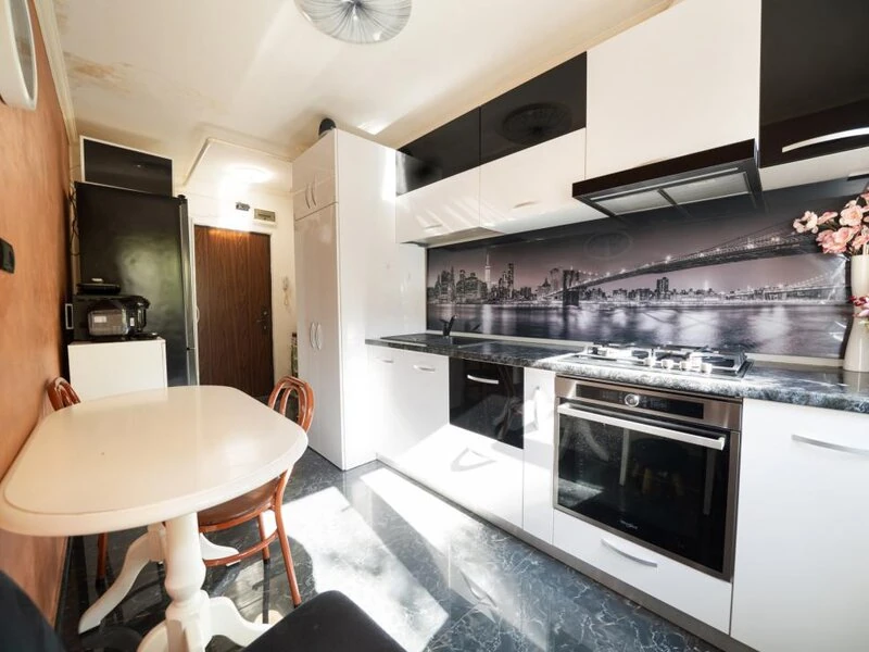 Renovated kitchen with gas hob, integrated oven and compact dining table