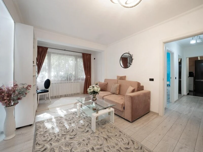 Renovated Bucharest lounge with sofa seating and a wide garden-facing window