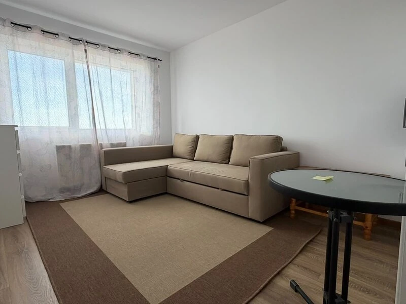 Flexible second room with corner sofa, round table and broad window