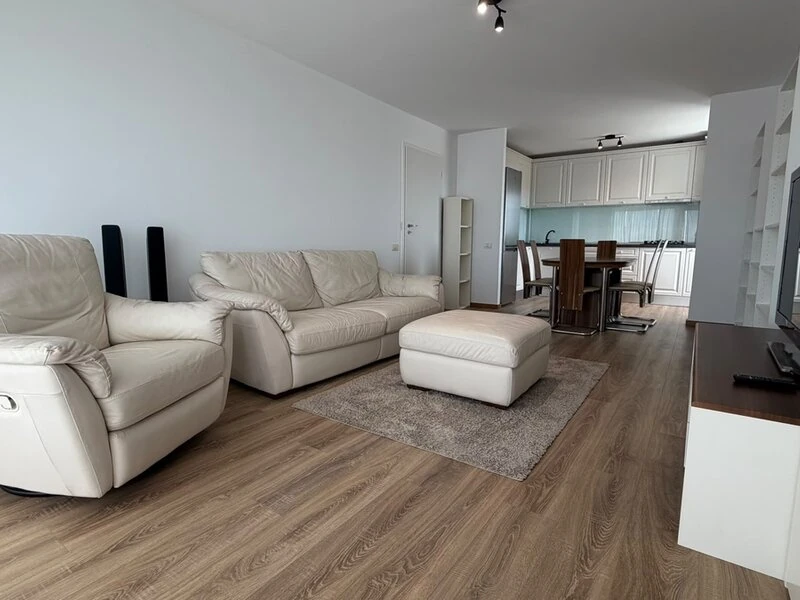 Open-plan Bucharest living room with dining area and white fitted kitchen
