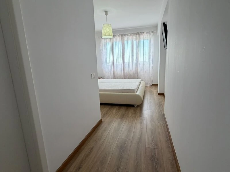 Timber-floored hallway leading into the bright double bedroom