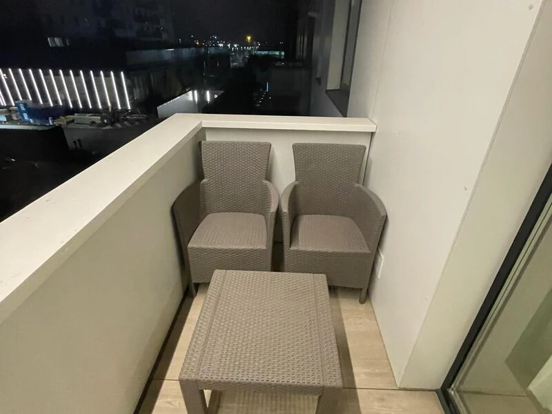 Private furnished balcony with night-time views across Cortina Nord Residence