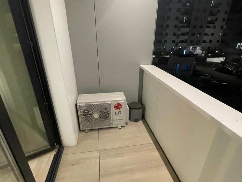 Private balcony with outdoor air-conditioning unit and northern Bucharest outlook