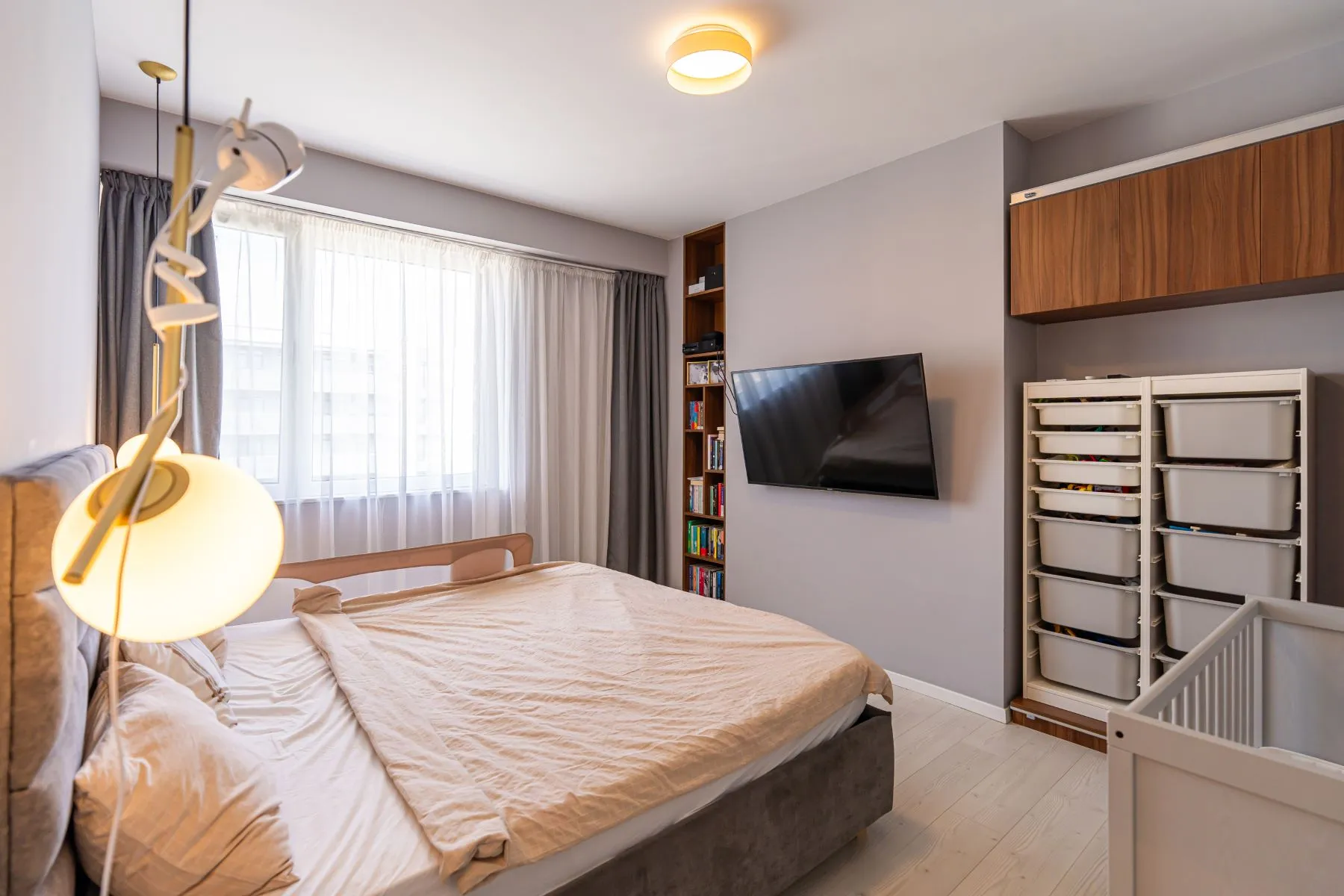 Second double bedroom with television, timber cabinetry and family furnishings