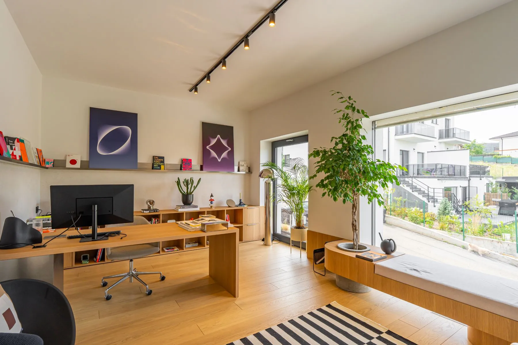 Executive office with timber workstation and wide residential outlook
