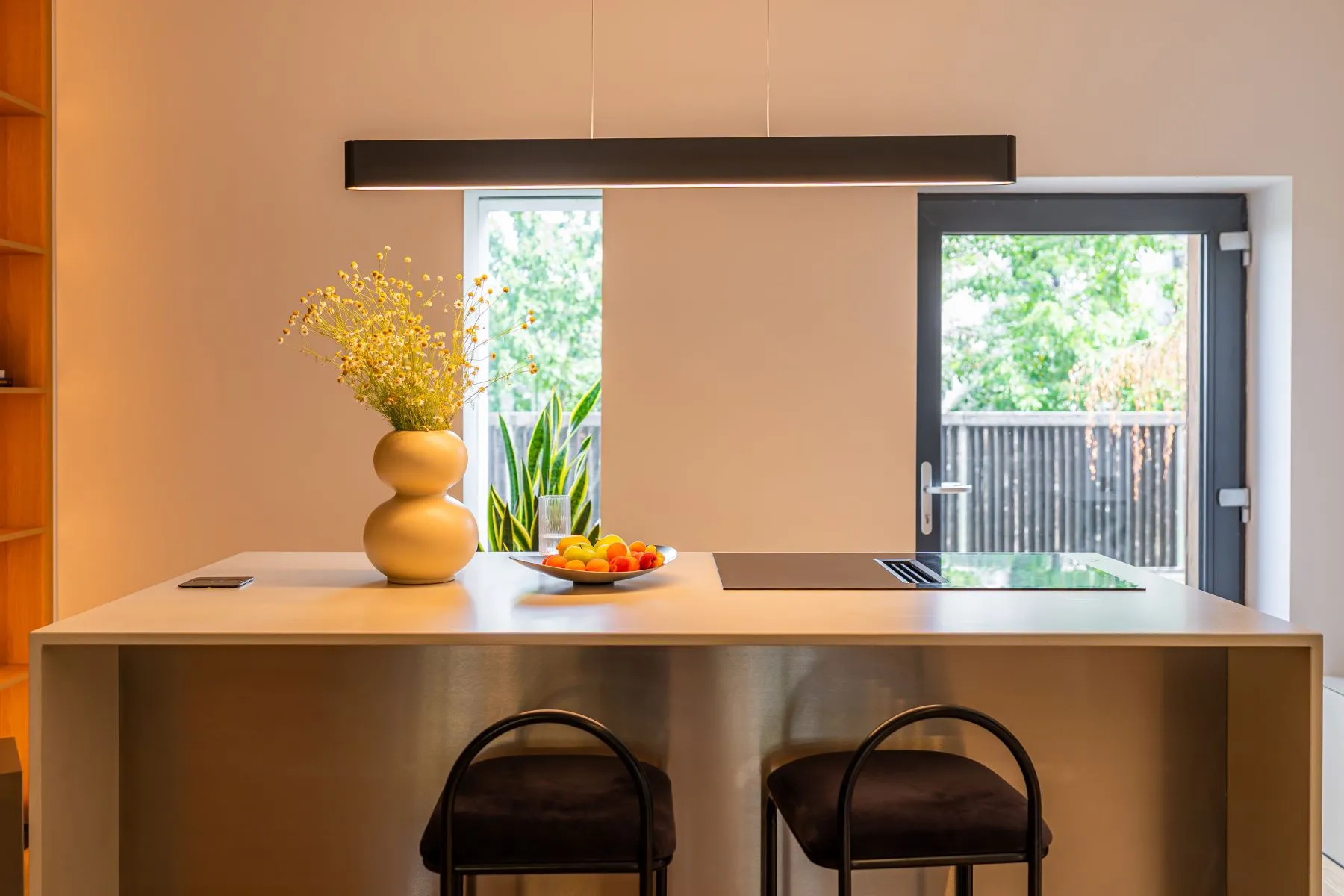 Kitchen breakfast bar with seating and direct access to the private garden
