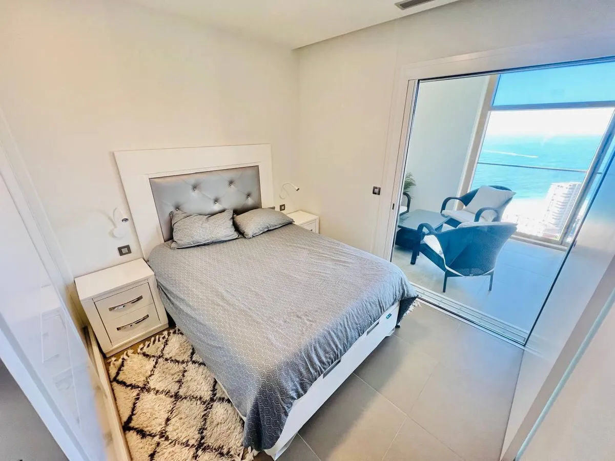 Double bedroom opening directly onto the sea-view balcony