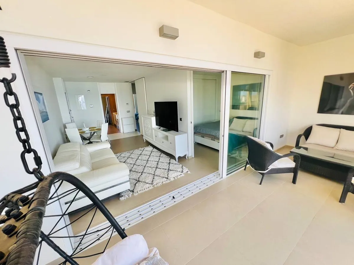 Panoramic private balcony with lounge seating and sea-facing windows