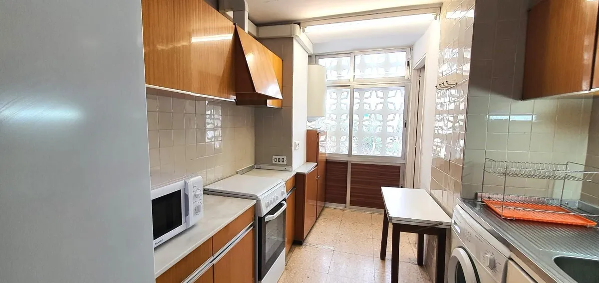 Separate fitted kitchen with timber cabinets and breakfast table