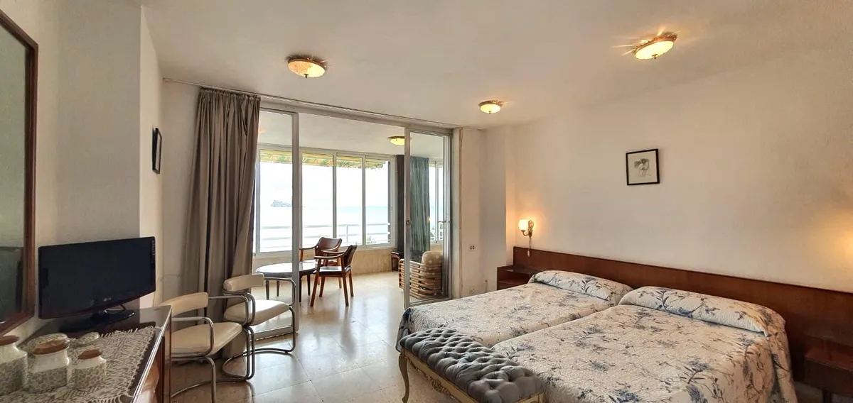 Spacious double bedroom with sitting area and balcony access