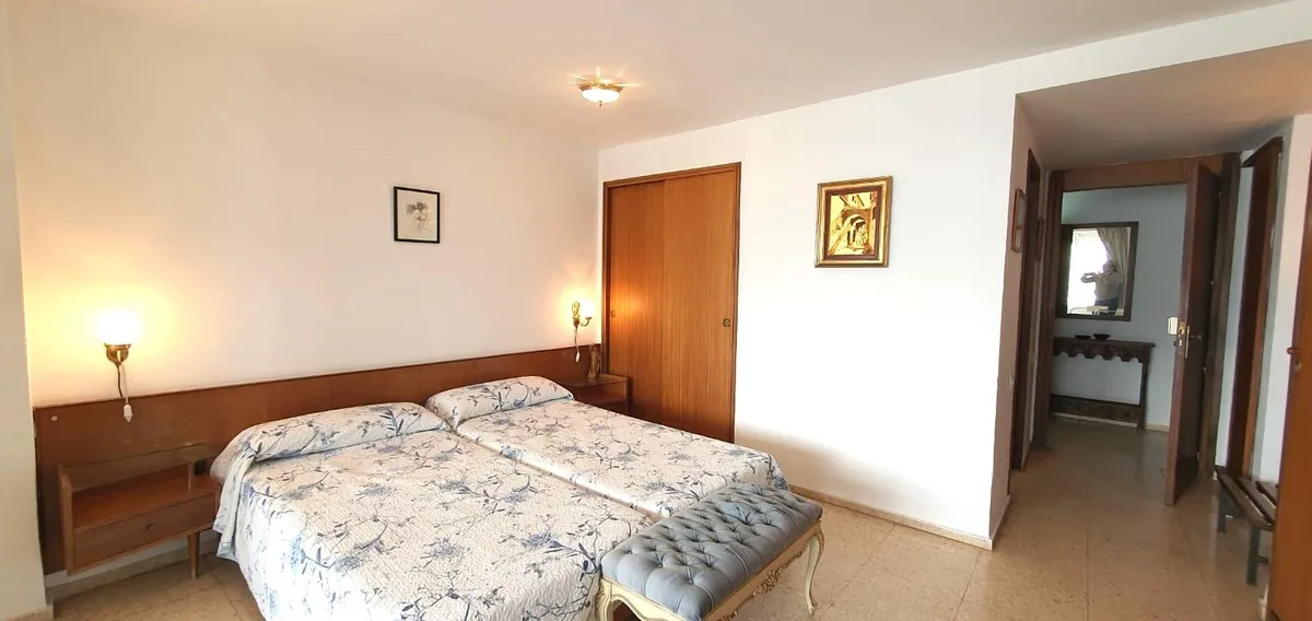 Double bedroom with bedside tables and adjoining bathroom corridor
