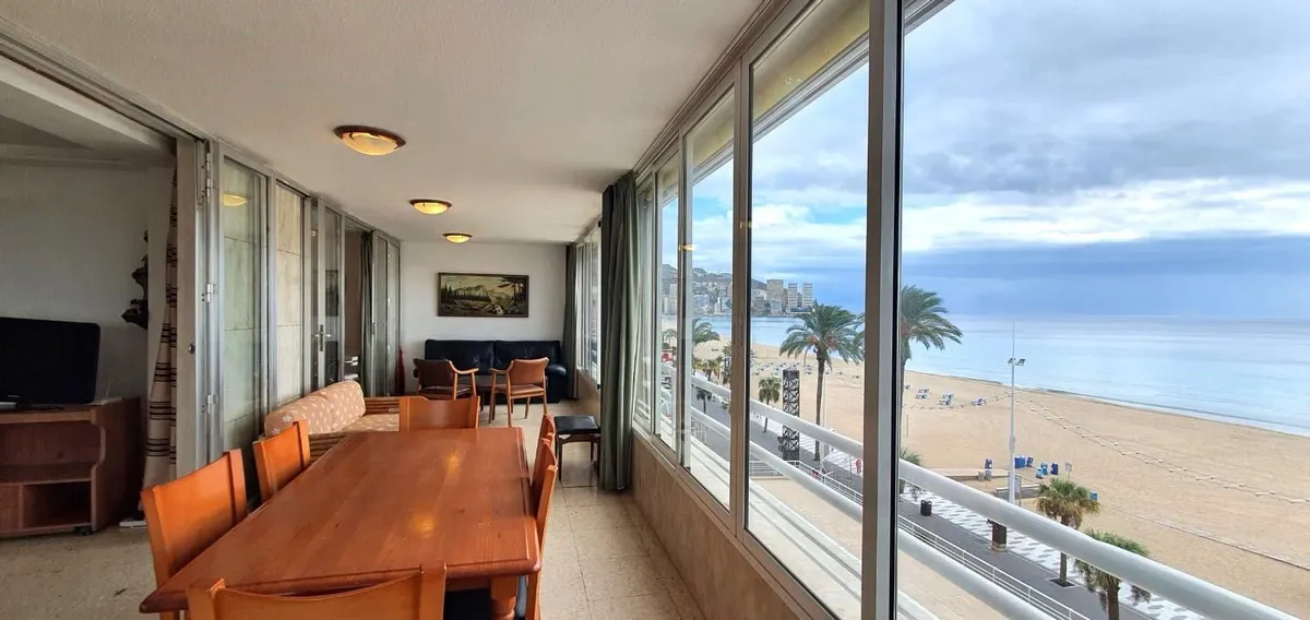 Long sea-view dining area beside floor-to-ceiling balcony windows