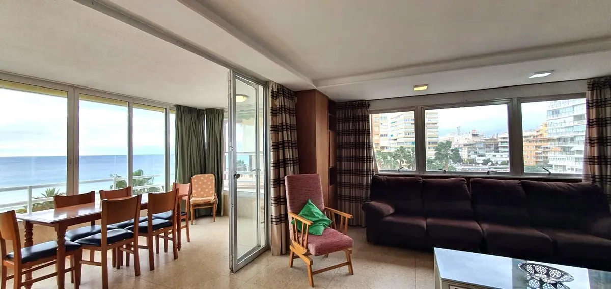 Spacious living room with dining area and panoramic coastal windows
