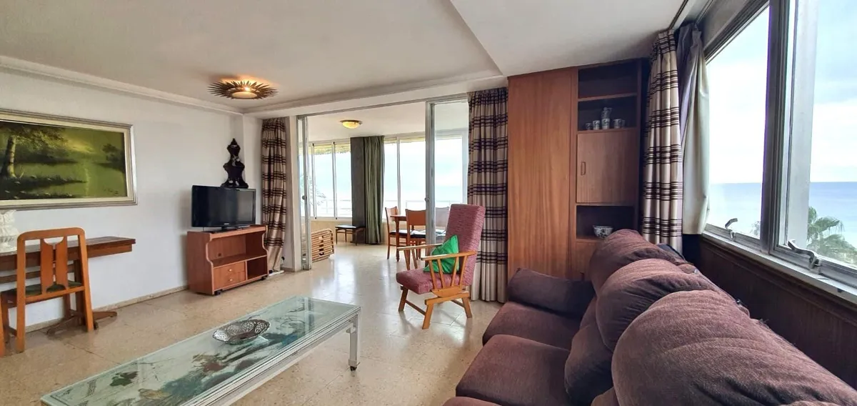 Comfortable lounge with dark sofa and Mediterranean views