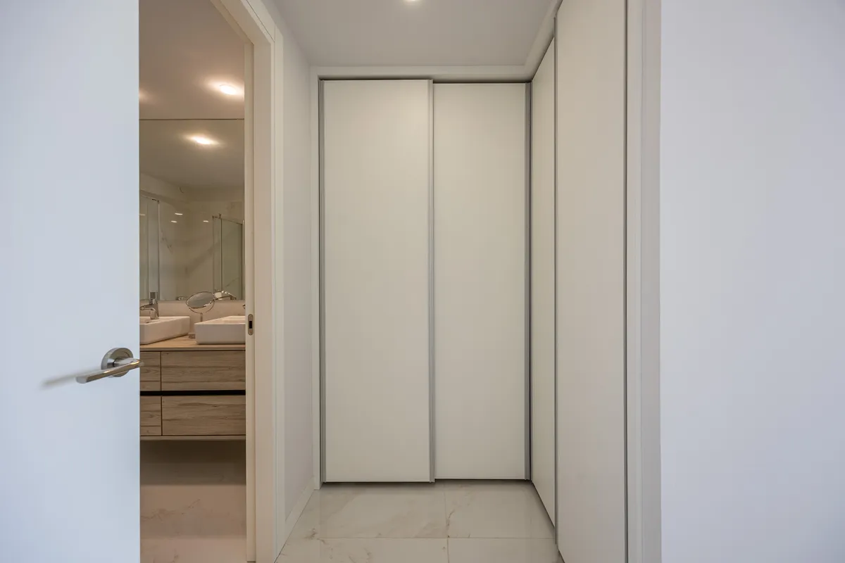 Full-height fitted wardrobes in the apartment’s bedroom corridor