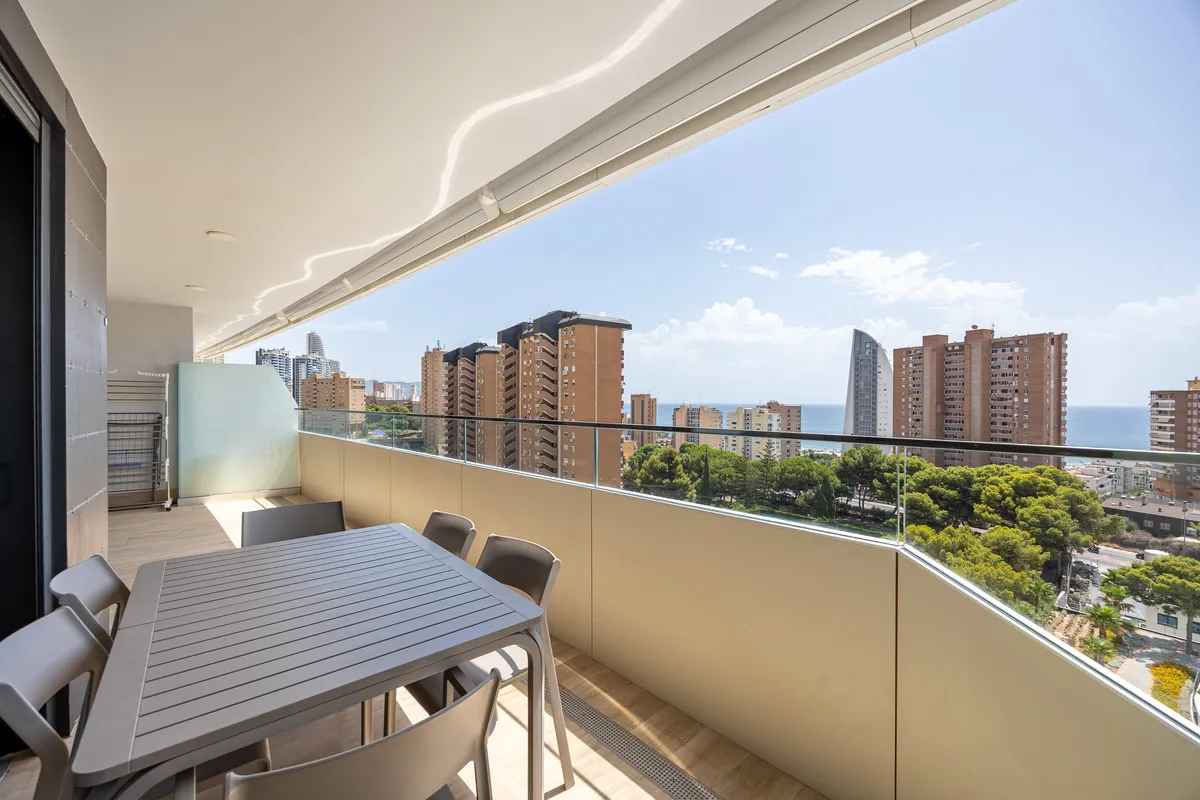 Private terrace dining table overlooking Benidorm and the distant sea