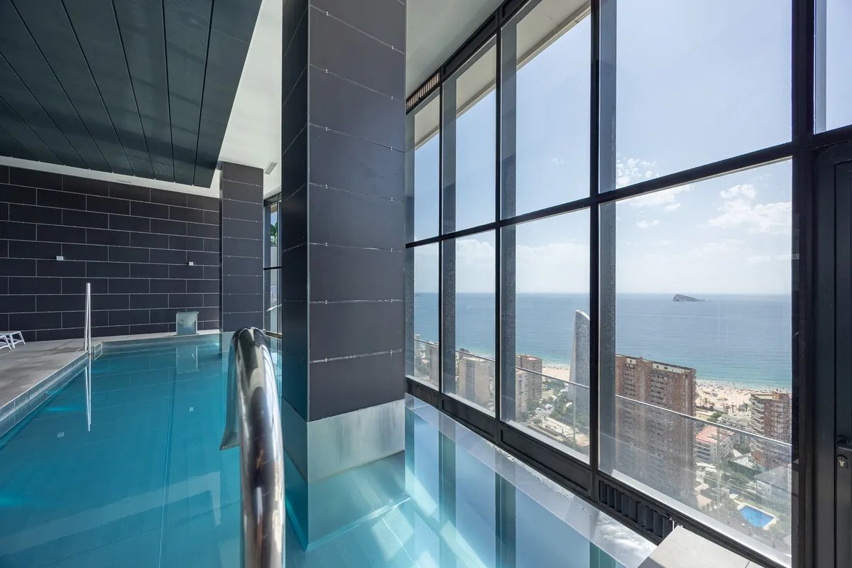 Indoor pool overlooking Poniente Beach and the Mediterranean coastline