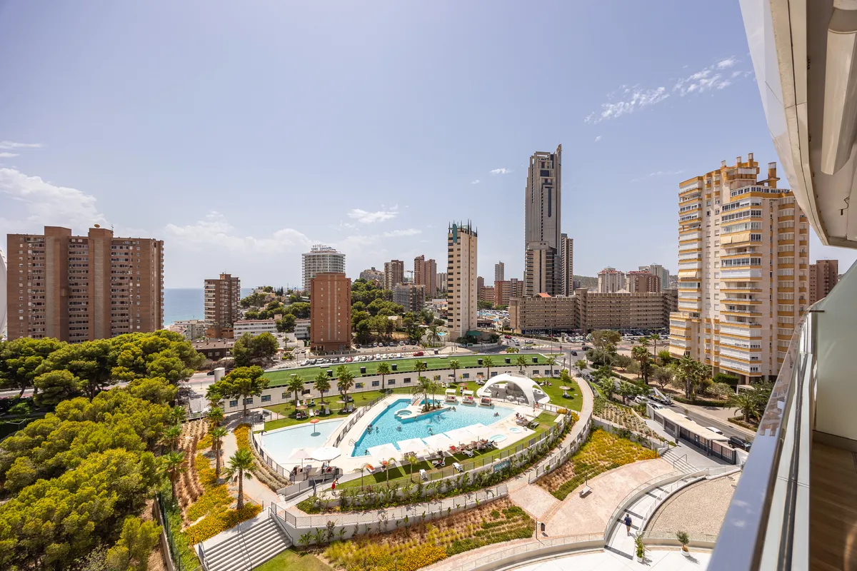 Multiple outdoor swimming pools viewed from the apartment terrace