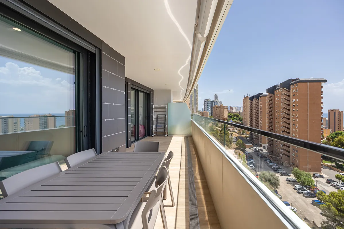 Long sixth-floor terrace with outdoor seating and open coastal outlook