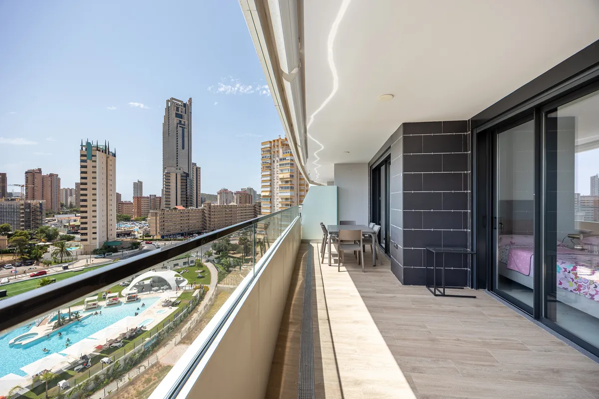 Elevated terrace view across the resort pools and Benidorm skyline