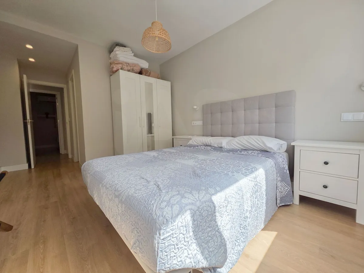 Principal bedroom with double bed, wardrobe and timber flooring