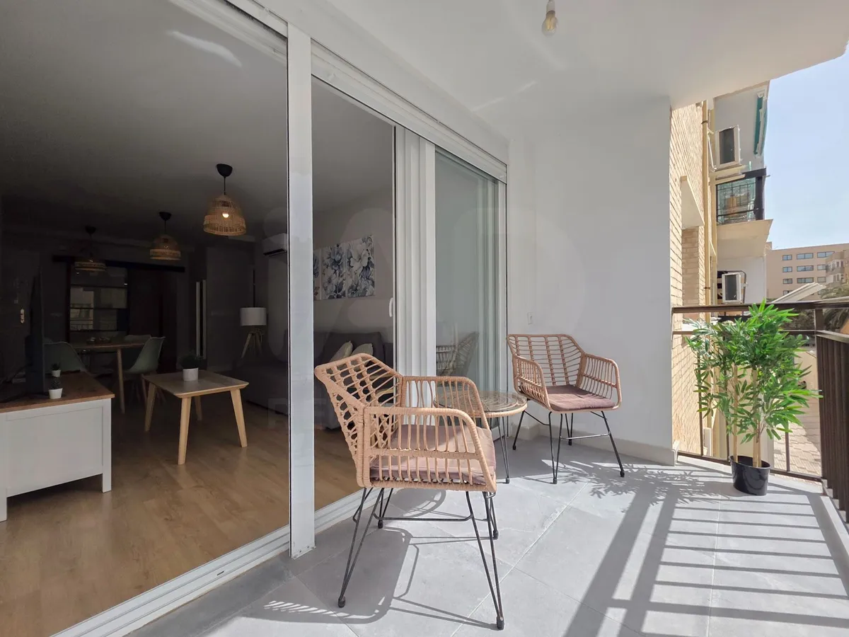 Private furnished terrace accessed through wide sliding glass doors