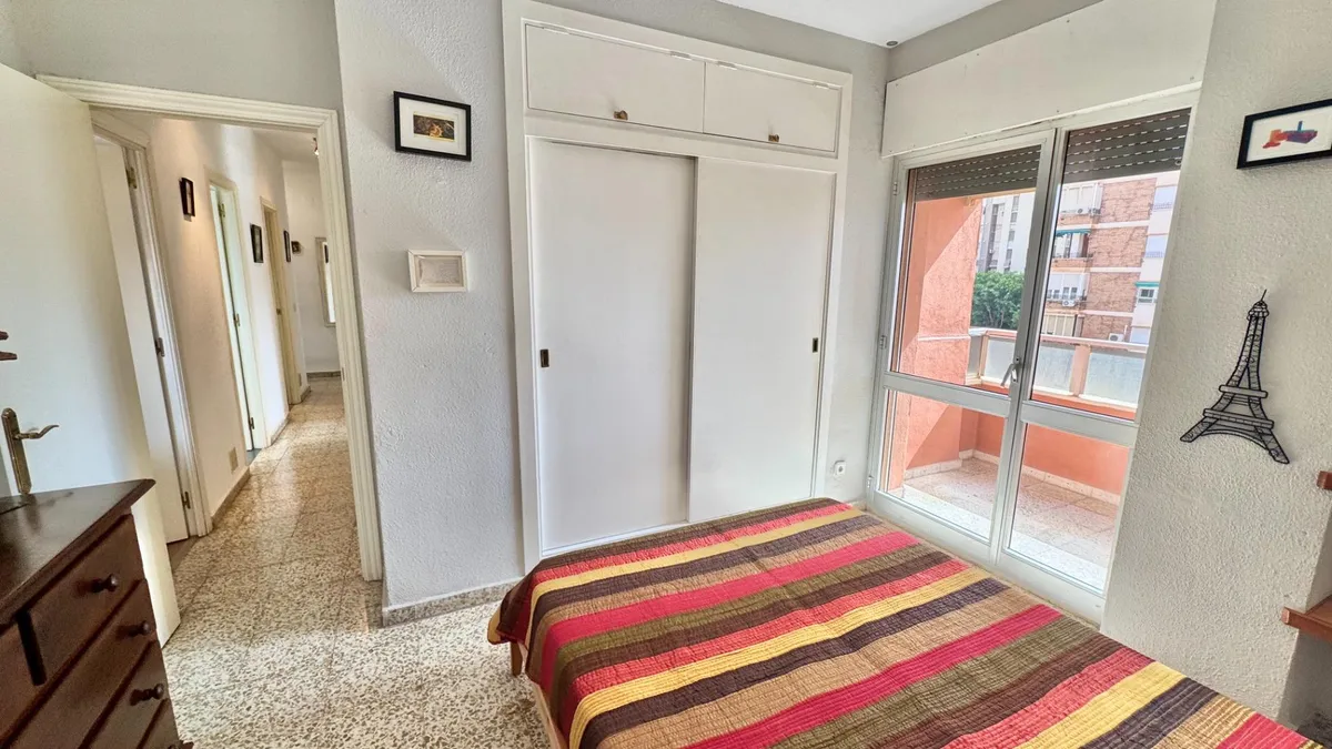 Double bedroom with fitted overhead storage and balcony access