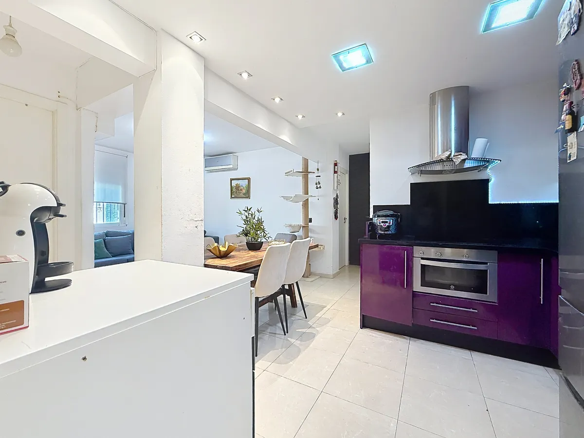 Modern kitchen with oven and extractor opening into the living room