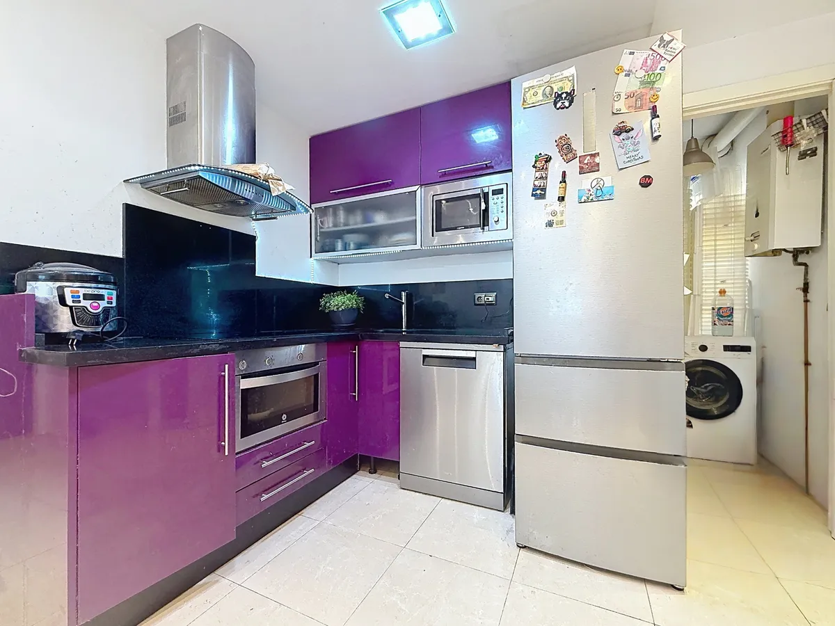 Purple integrated kitchen with oven, dishwasher and full-height refrigerator
