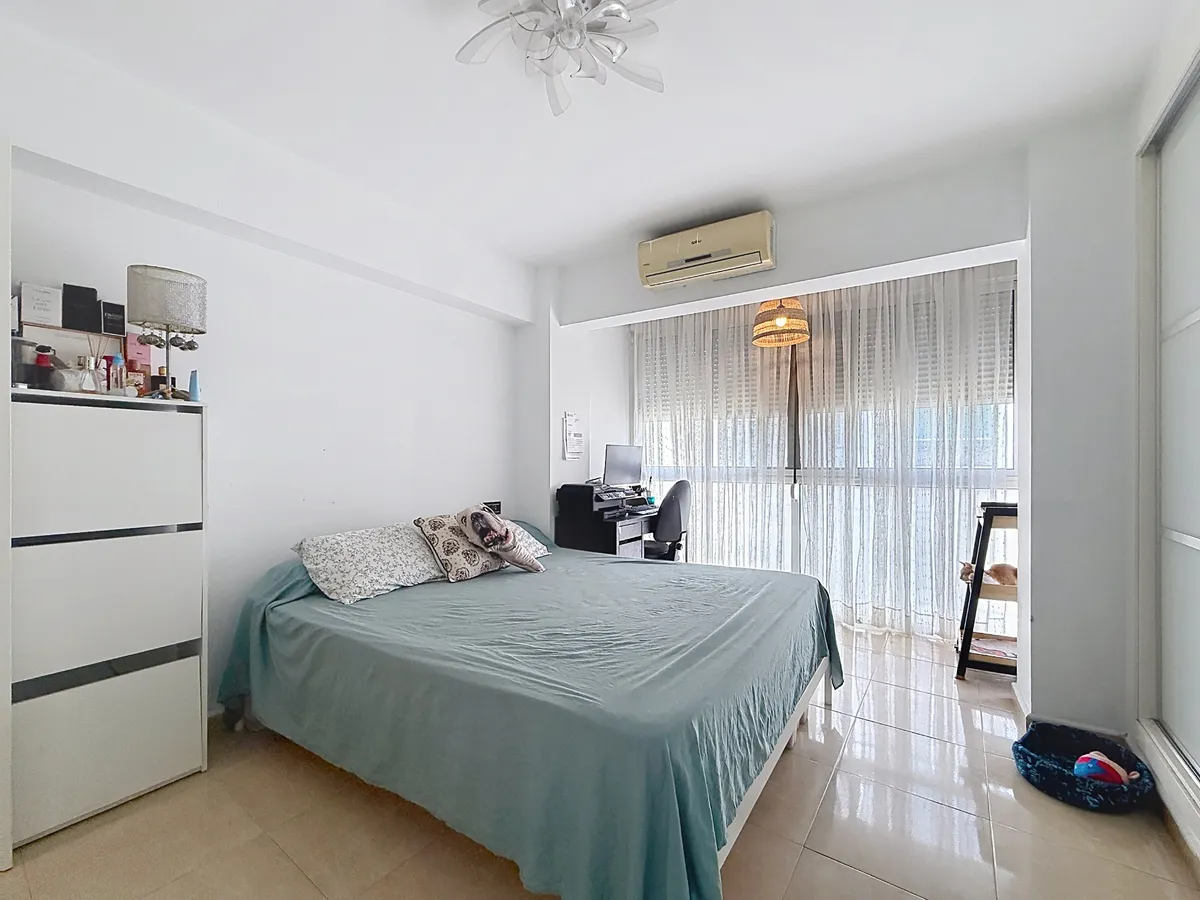 Air-conditioned principal bedroom with double bed and fitted wardrobes