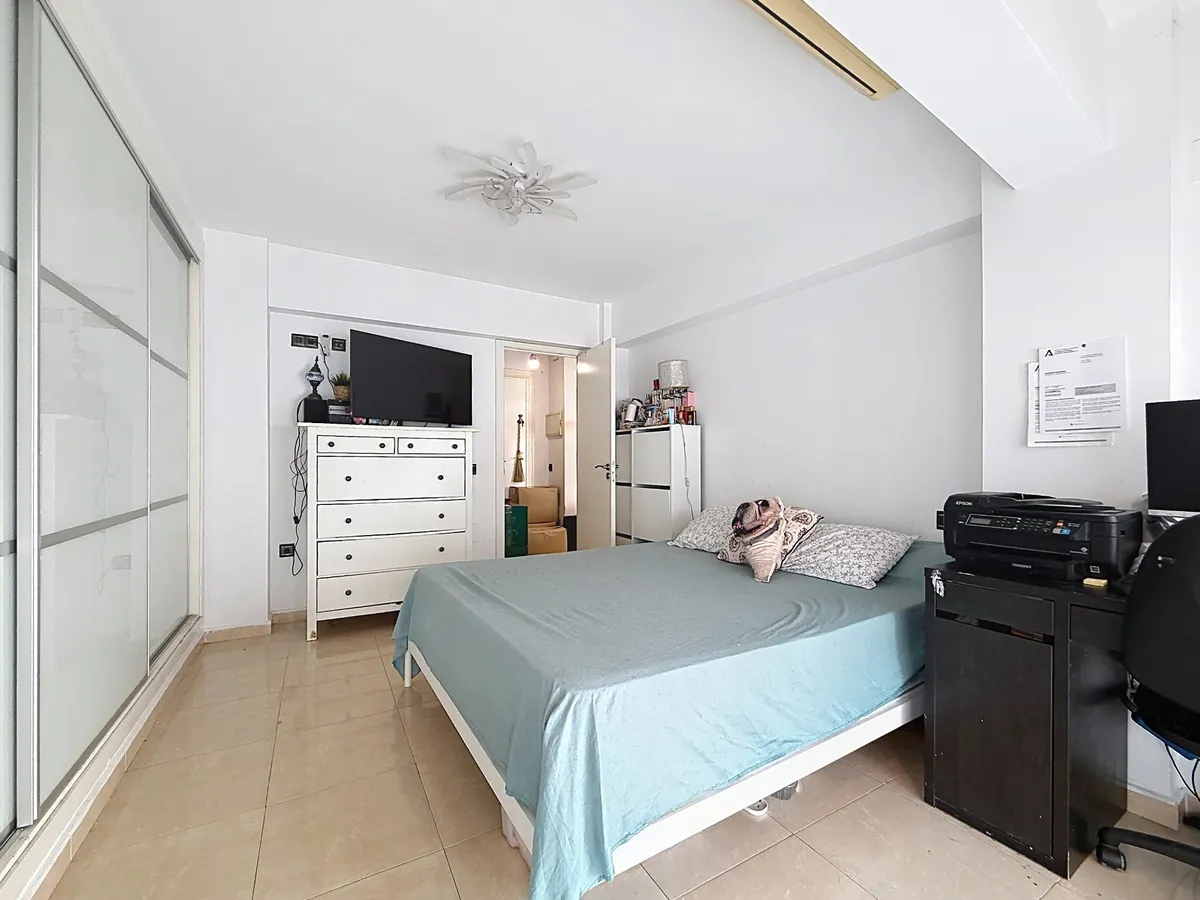 Principal double bedroom viewed toward the dresser and entrance