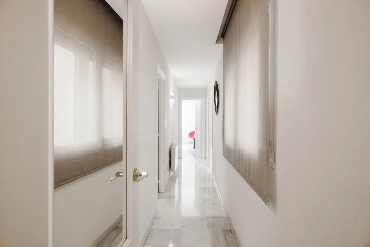 Central hall opening toward the kitchen, dining room and bedrooms