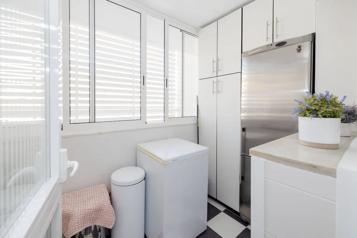 Separate utility room with laundry sink and household equipment