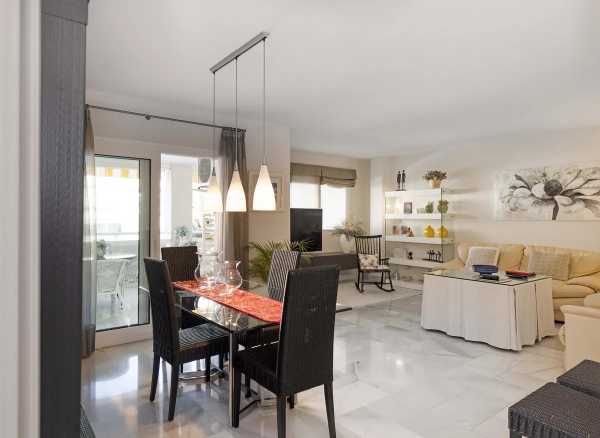 Dining table beside wide sliding doors leading to the private terrace