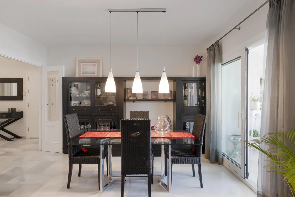 Spacious living and dining room with cream seating and marble floor
