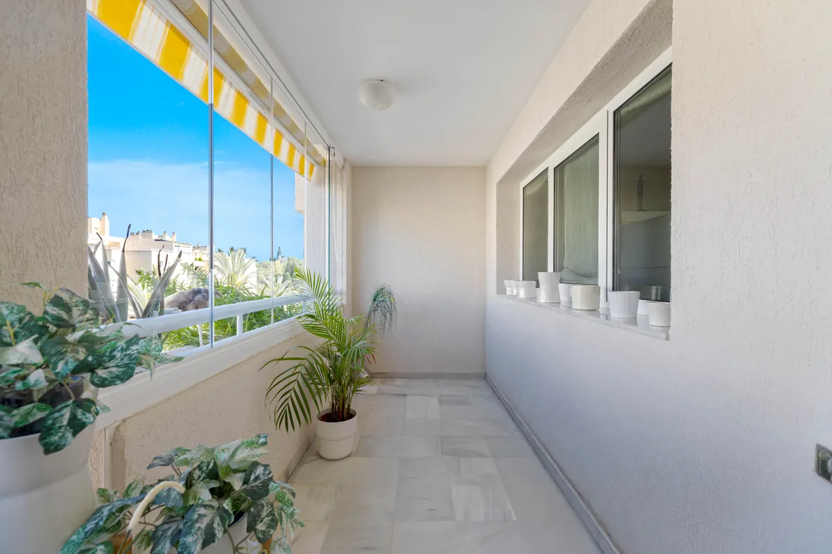 Long sheltered terrace with retractable awning and open neighbourhood views