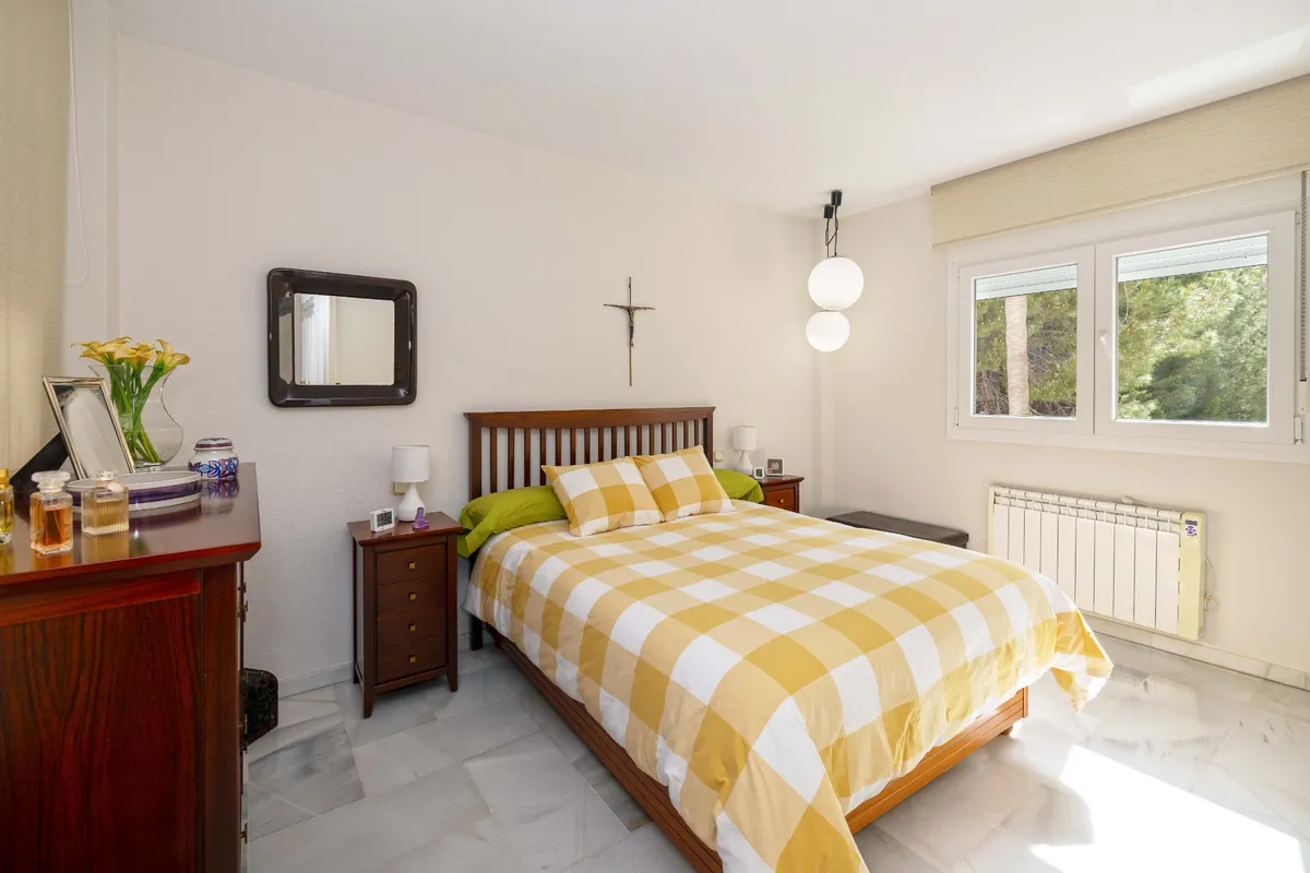 Garden-facing double bedroom with fitted wardrobes and marble floor