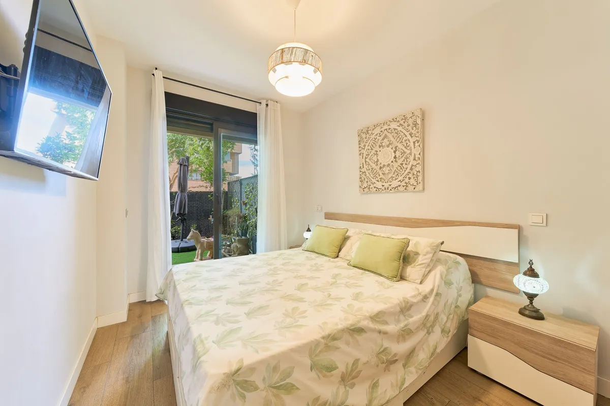 Garden-facing principal bedroom with double bed and terrace doors
