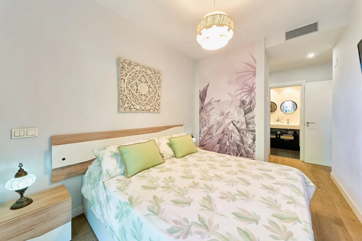 Principal double bedroom with feature wall and en-suite access