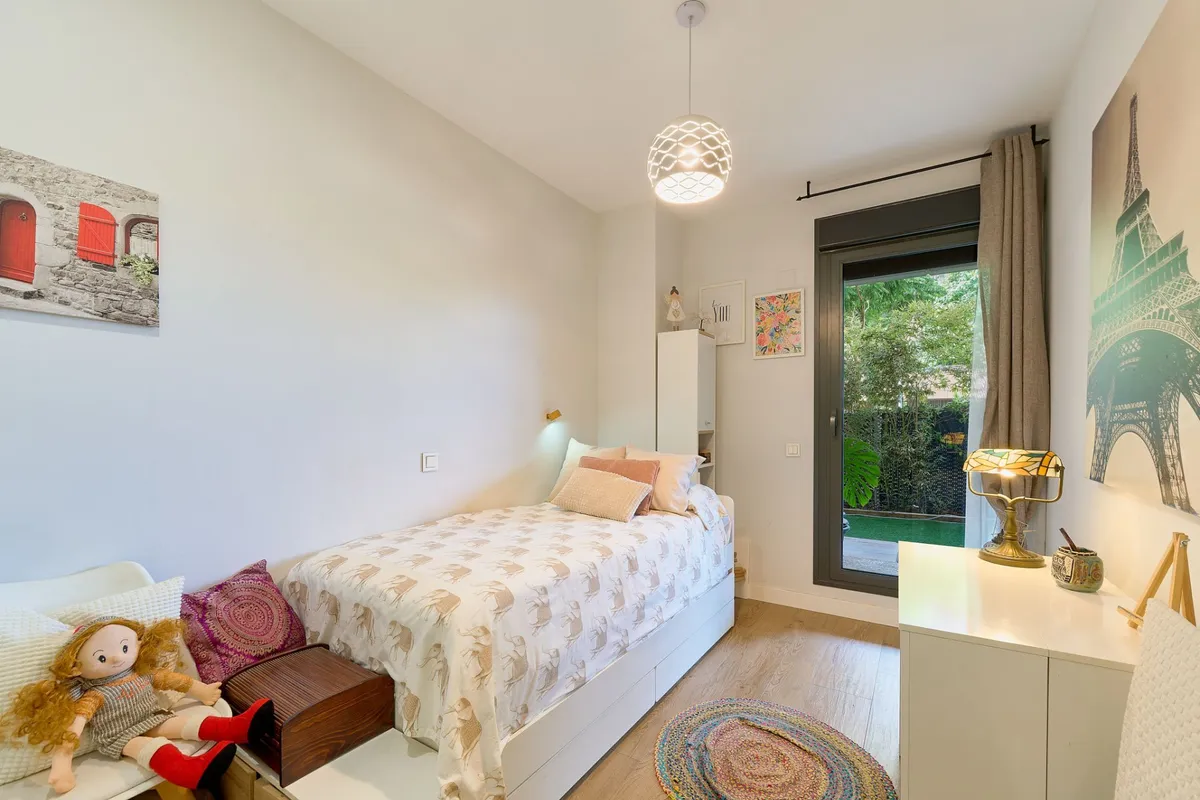 Bright third bedroom with single bed, desk and terrace door