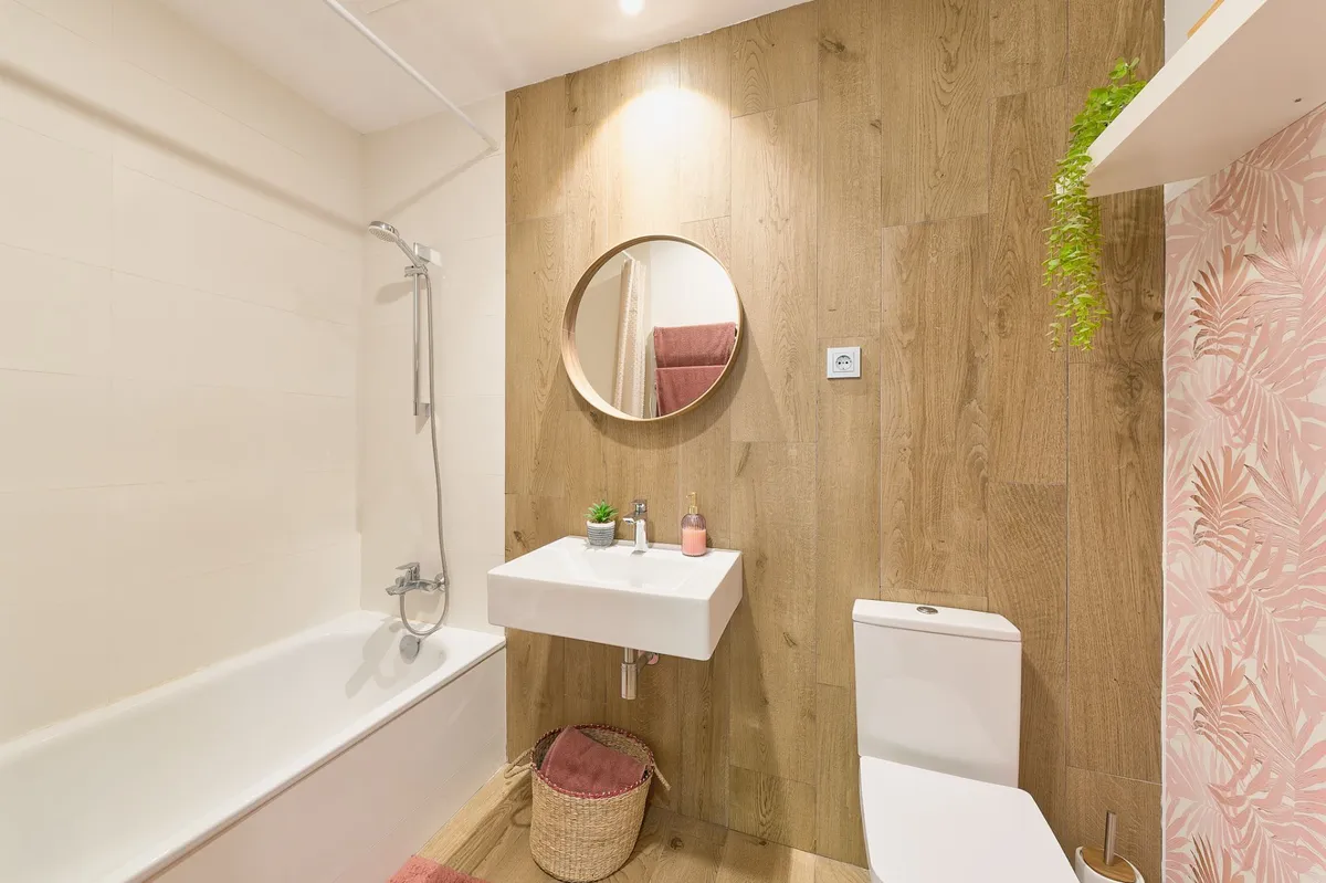 Second bathroom with bathtub, overhead shower and timber-effect wall