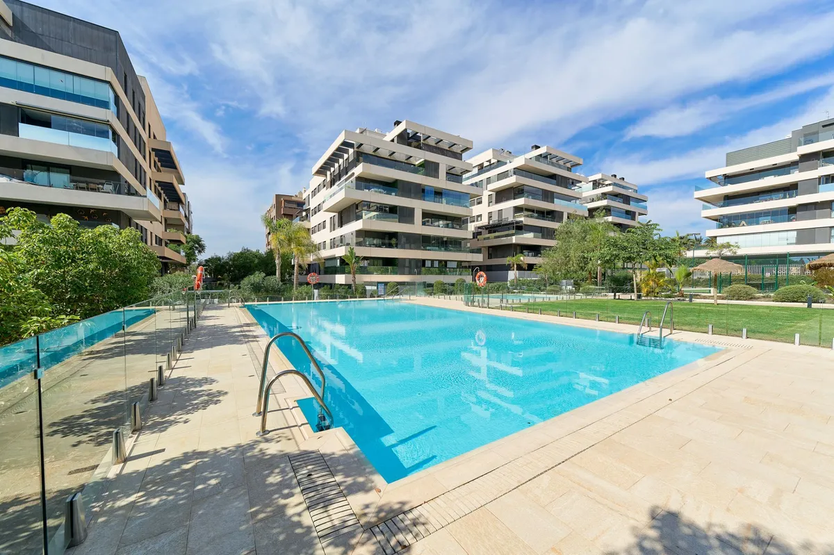 Large outdoor swimming pool within the landscaped residential development